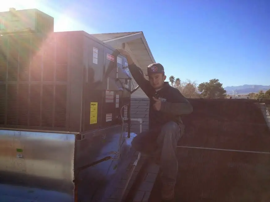 HVAC technician performing AC Tune-Up on a rooftop unit in Cape Girardeau